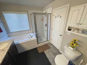 Main Bathroom with a garden tub, a stall shower, and vanity