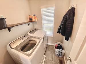Washroom featuring separate washer and dryer and tile patterned floors
