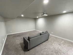 Carpeted home theater featuring recessed lighting and baseboards