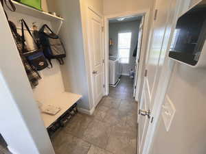 Mudroom featuring separate washer and dryer and baseboards