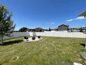 View of yard featuring a patio area and an outdoor fire pit