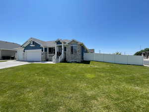 View of front of property featuring an attached garage, driveway, board and batten siding, and brick siding