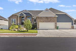 Craftsman-style home featuring a garage and concrete driveway
