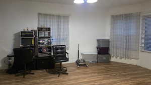 Home office featuring wood finished floors and ornamental molding
