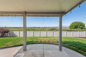 Fenced backyard featuring a patio area and a mountain view