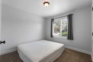 Carpeted bedroom with baseboards