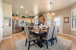 Dining room with a chandelier, recessed lighting, and light wood finished floors