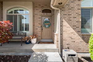 Entrance to property with brick siding