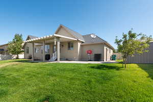 Rear view of house with a patio area and stucco siding