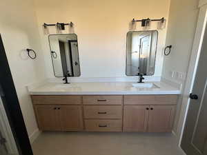 Full bath with double vanity and tile flooring