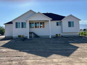 Rear view of house featuring stucco siding