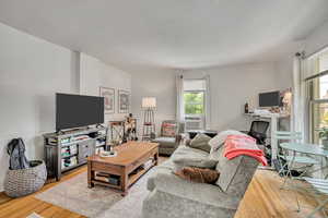 Living area featuring wood finished floors and cooling unit
