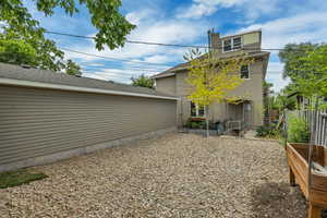 Back of house with a vegetable garden