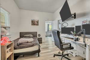 Bedroom featuring light wood-style flooring and a desk