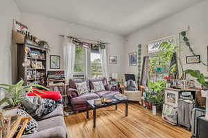 Living area with healthy amount of natural light and wood-type flooring
