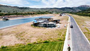 Aerial view of property and surrounding area with a water and mountain view