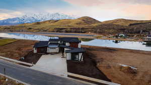 Aerial view of property and surrounding area featuring a water and mountain view