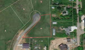 Aerial map of property and surrounding area featuring property boundaries highlighted