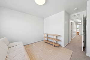 Sitting room featuring light colored carpet and baseboards