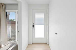 Doorway to outside with plenty of natural light and light wood-type flooring