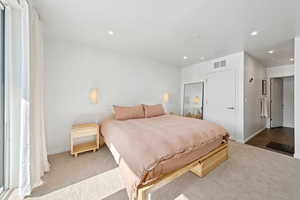 Carpeted bedroom with recessed lighting