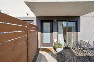 Property entrance with stucco siding