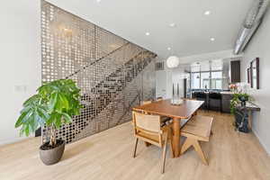 Dining space with light wood-type flooring and recessed lighting