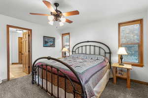 Bedroom featuring carpet flooring and baseboards