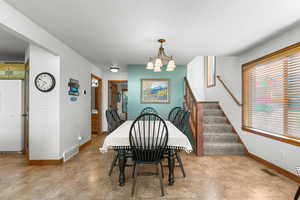 Dining area featuring a chandelier and stairway