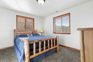 Carpeted bedroom with baseboards
