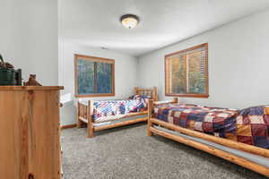 Carpeted bedroom featuring baseboards