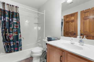 Bathroom with vanity and shower / bath combination with curtain