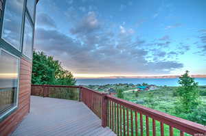 Deck at dusk featuring a water view