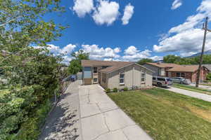 View of front of property with long driveway and RV pad.