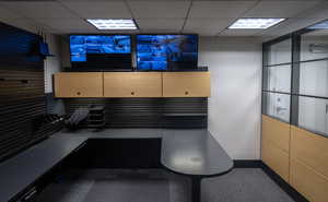 Misc room featuring a paneled ceiling, carpet flooring, and an office area