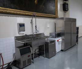 Kitchen featuring stainless steel appliances and tile walls