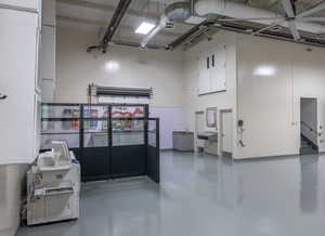 Misc room with finished concrete floors