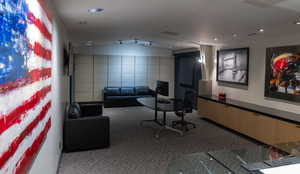 Interior space with lofted ceiling, tile walls, and recessed lighting
