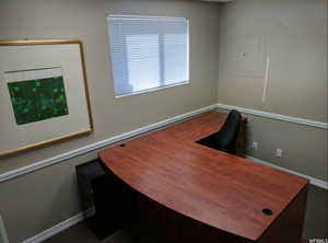 Office area with electric panel and baseboards