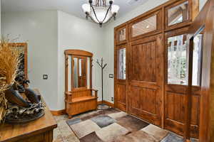 Foyer featuring stone tile flooring and a bench