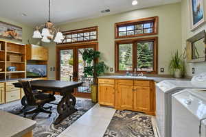 Laundry room with washer and dryer, cabinet space, french doors, a chandelier, and recessed lighting