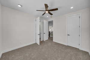 Unfurnished bedroom with carpet, recessed lighting, and a ceiling fan