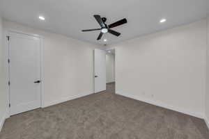 Unfurnished bedroom featuring carpet floors, recessed lighting, and a ceiling fan