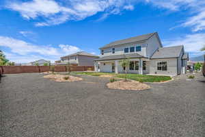 Back of property featuring stucco siding and a tile roof