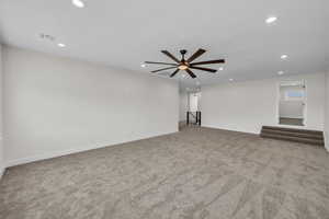 Carpeted empty room with recessed lighting and ceiling fan