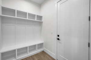 Mudroom with baseboards and wood finished floors