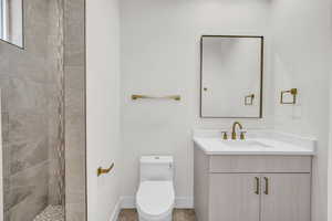 Bathroom featuring vanity and a tile shower