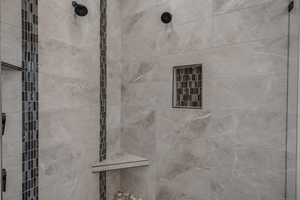 Full bathroom featuring a tile shower