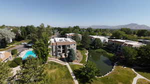 Aerial view of a pool area and a water and mountain view