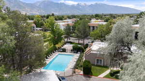 Drone / aerial view of a pool area and a mountain backdrop